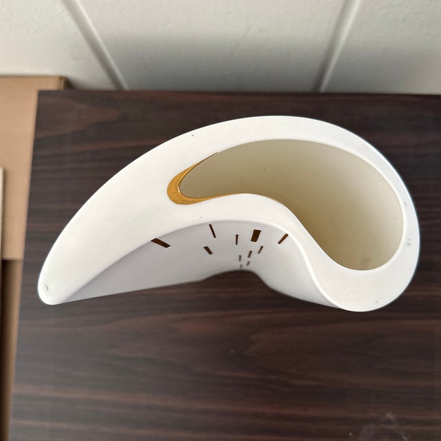 Elegant vintage porcelain vase featuring a sculptural, asymmetrical form with softly undulating edges. Finished in a crisp...