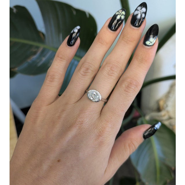A 1.51-carat oval lab grown diamond takes centre stage in this solid 14K white gold ring, lined with twelve lab grown...