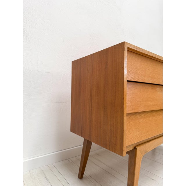 Beautiful vintage walnut chest of drawers from germany, dating to the late 1950s. The design is defined by its clean...