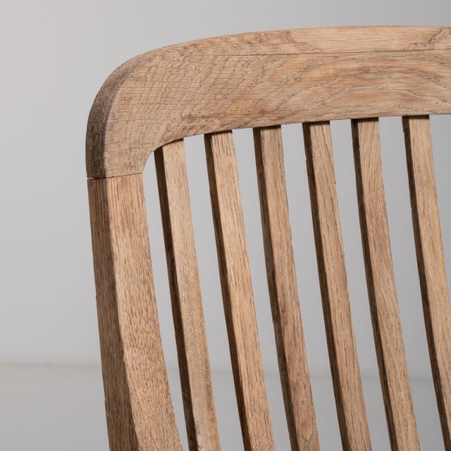 Rendered in warm, richly grained French oak, this early twentieth-century dining chair embodies the refined restraint...