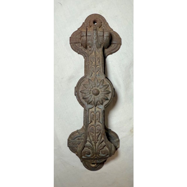 This large antique ornate Eastlake Aesthetic cast iron front door mount knocker is a unique and stylish addition to any...
