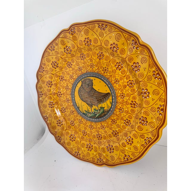 A striking hand-painted majolica plate that features a traditional stylized owl design crafted in the world-renowned...