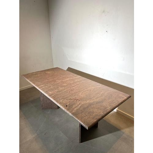 Impressive vintage dining table crafted entirely from solid granite. The rectangular top rests on two monumental slab...