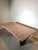 Impressive vintage dining table crafted entirely from solid granite. The rectangular top rests on two monumental slab...