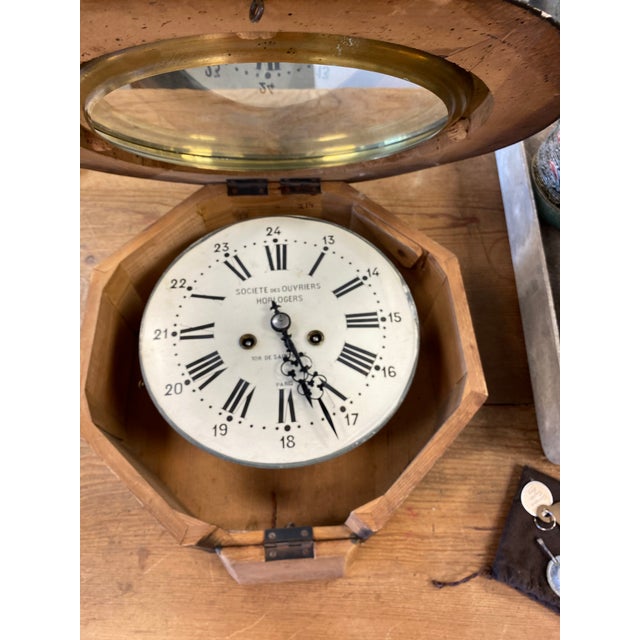 Lovely antique French wall clock with key. Round face with octagonal housing and top hinge. Face is marked "Societe des...