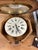 Lovely antique French wall clock with key. Round face with octagonal housing and top hinge. Face is marked "Societe des...