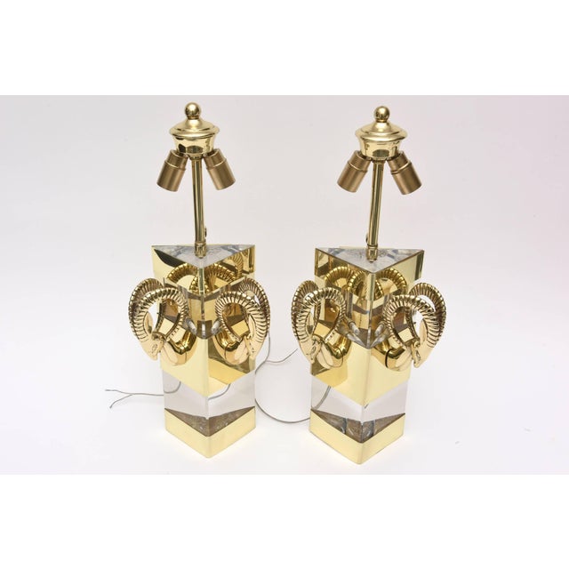 These fabulous and dramatic lucite and brass Hollywood Regency wall sconces have the ram’s heads on either side. They have...