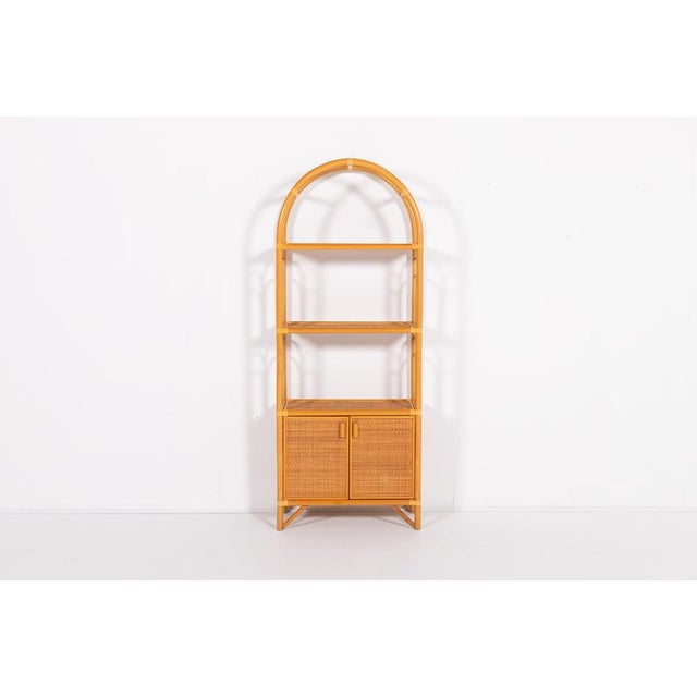 Beautiful Italian design bamboo and rattan combination cabinet from 1980’s. The piece features 2 shelfs and 2 doors with...