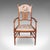This is an antique elbow chair. An English, needlepoint over beech and mahogany morning room seat in Art Nouveau taste,...