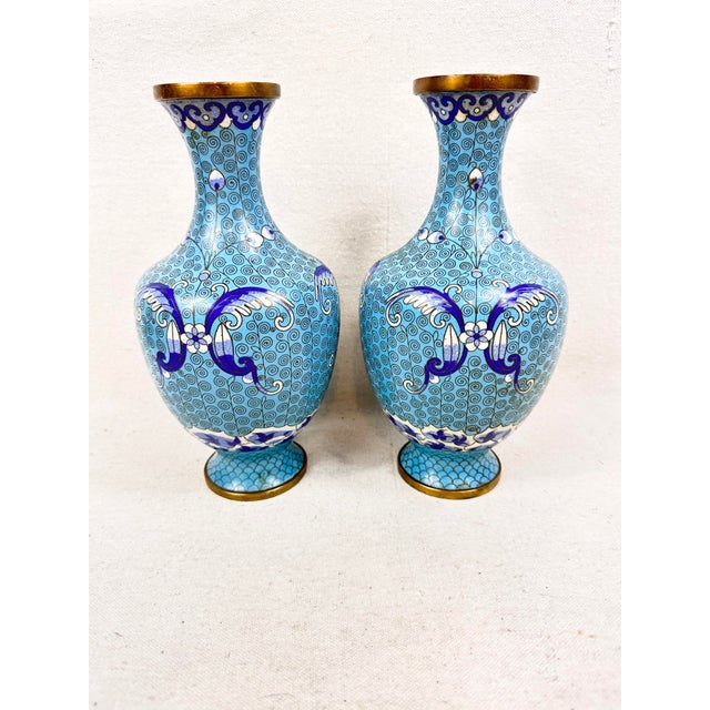 Presenting an elegant pair of vintage Chinese cloisonné enamel vases. Each matching vessel features a classic baluster...