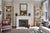 A handsome pair of Brentwood bookcases purchased from the Nancy Corzine showroom finished in a rich gilt that catches the...