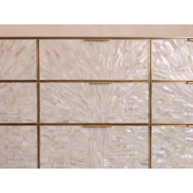 A luminous statement in natural mother-of-pearl and brushed brass, the Arcana Nine-Drawer Dresser brings together...