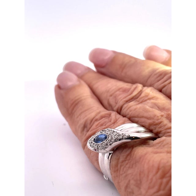 This 18K White Gold Diamond Tanzanite Head Snake Ring was made after 1960 as that is when the mines in Tanzania opened...