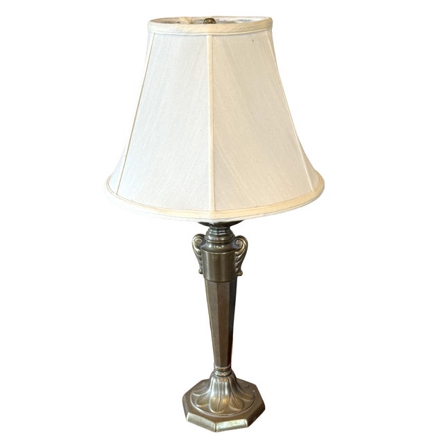 This substantial, high-quality table lamp features a beautifully detailed antiqued brass (or bronze-finished) base with a...