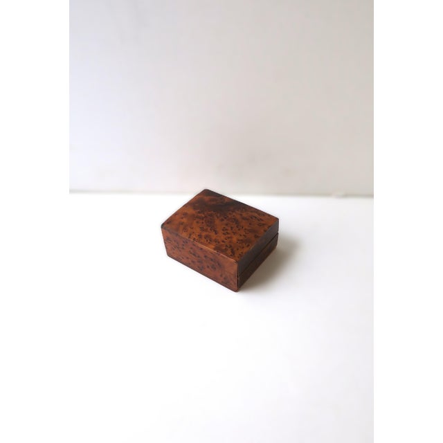 A relatively small rectangular burl wood trinket box, in the Modern design style, circa mid-20th century. Crafted in a...