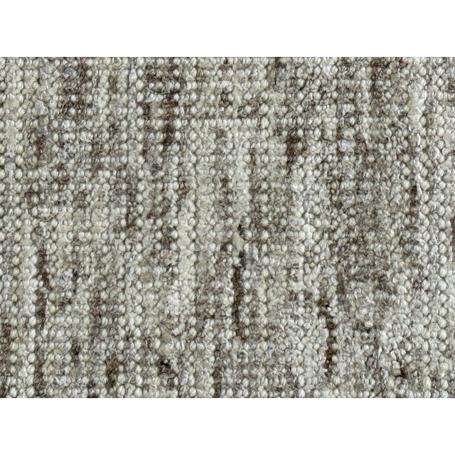 Design Plus Gallery presents a 10ft × 13ft Flatweave Area Rug. This contemporary rug has a low-profile woven construction...