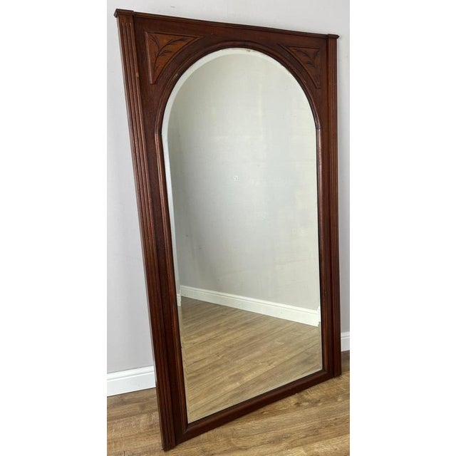 An elegant Antique French mirror in Oak, featuring a tall arched form with a rich warm finish and refined carved...