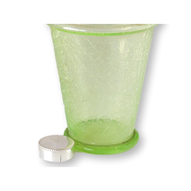 Striking Art Deco cocktail shaker in pale green crackle glass, topped with a silver-plated strainer lid and cap. Generous...