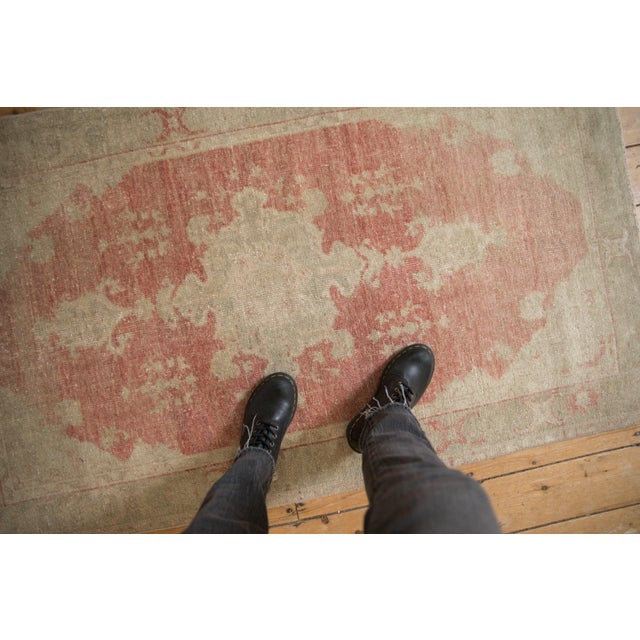 :: Turtle stylized center medallion adorned at either end by oversize finials atop an abrashed ground field and minor...