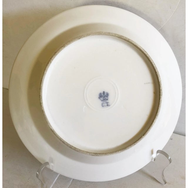 This set of five lovely plates have scattered wild flowers within the bowl and along the rim of each piece. The gold...