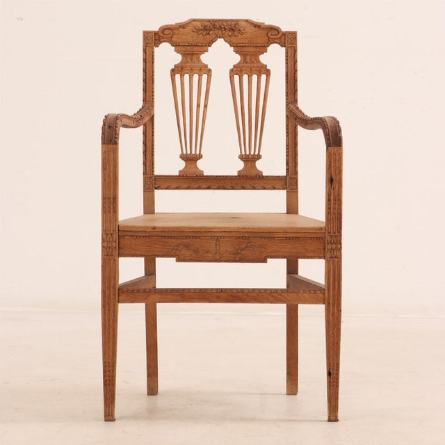 This pair of solid oak armchairs is all delicately hand carved with shaped crests adorned with foliate motif, above double...