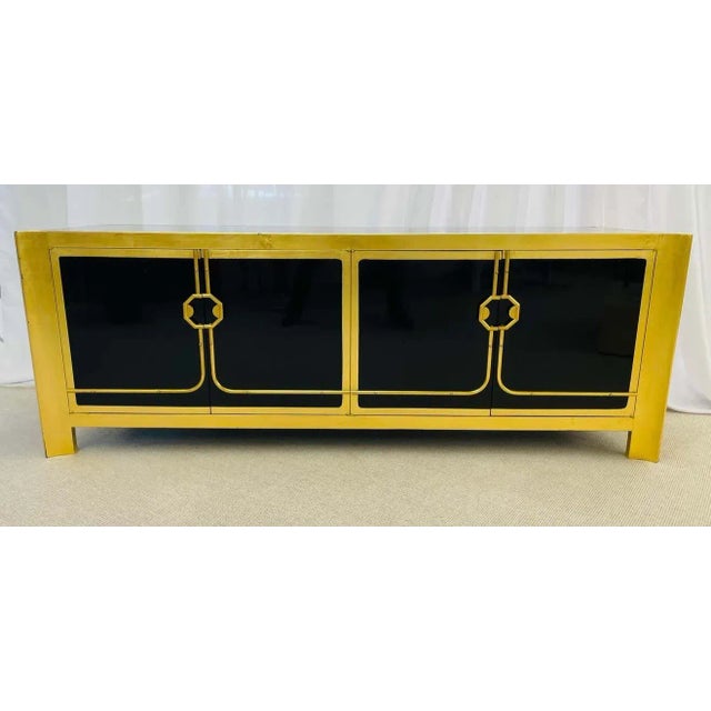 A Mastercraft Mid-Century Modern sideboard. Ebony and gilt gold. A sleek and stylish Asian inspired sideboard cabinet by...