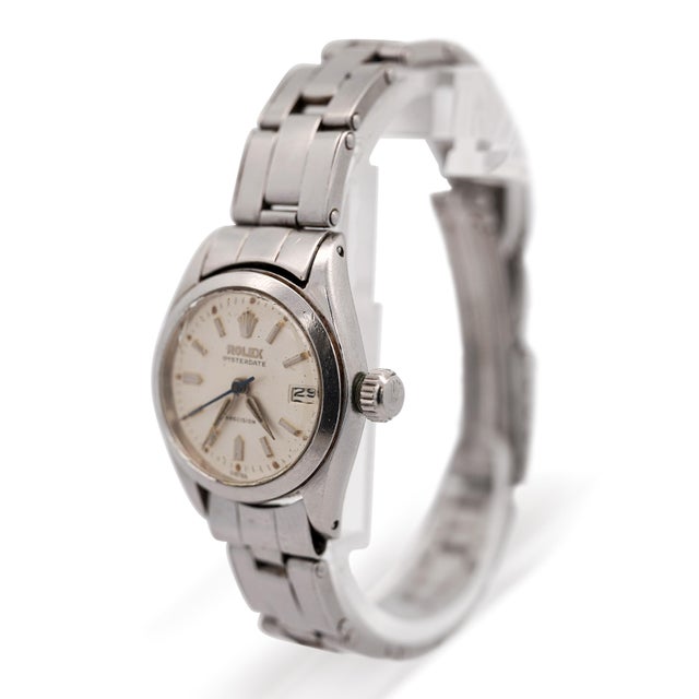 This vintage Rolex Oysterdate Precision reference 6406 features a cream-tone dial with gold-tone baton indices, dauphine...