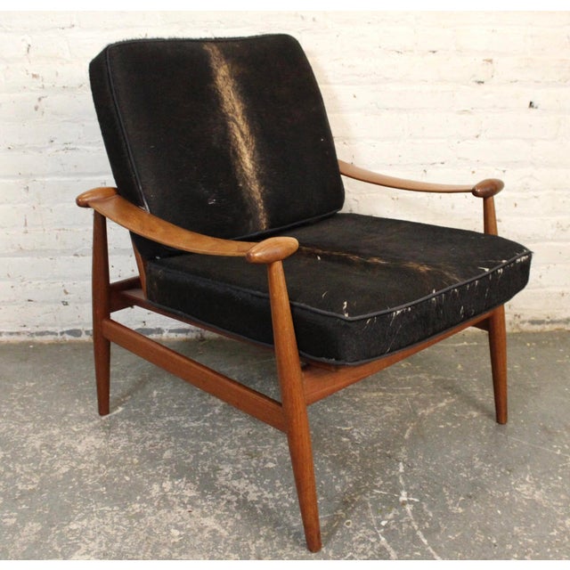 This is the "Spade Chairs" by Finn Juhl. The frame is made of teak and the cushions are upholstered in cowhide. This piece...