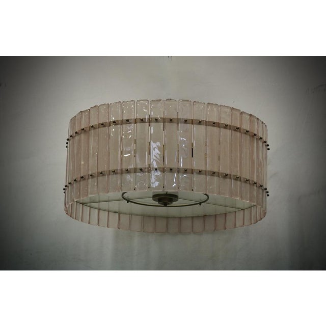 Superb chandelier/ceiling light in a striking light pink colour; a perfect round with pink glass plates. Its structure is...