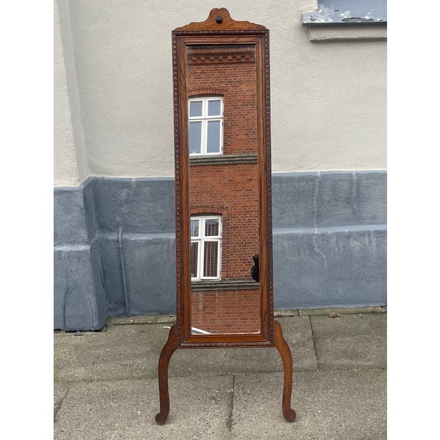 A stylish, elegant and lean English Cheval/standing mirror with hand-carved oak frame. Made in England during the late...