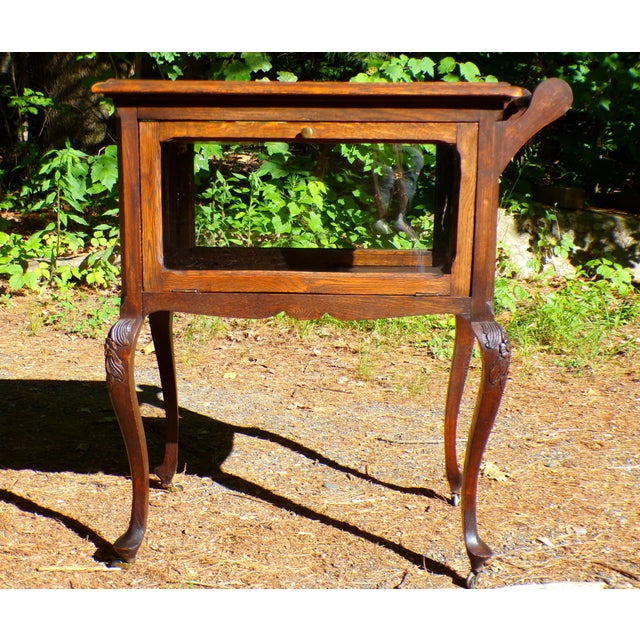 Charming early 20th century tea / liquor cabinet display serving cart with original rolled glass panels on all sides. The...