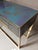 Discover our artistic glass console table with two drawers, featuring elegant blue glass accented with gold leaf and...
