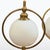A pair of table lamps from the first half of the 20th century, crafted from solid brass and opaline glass. The spherical...