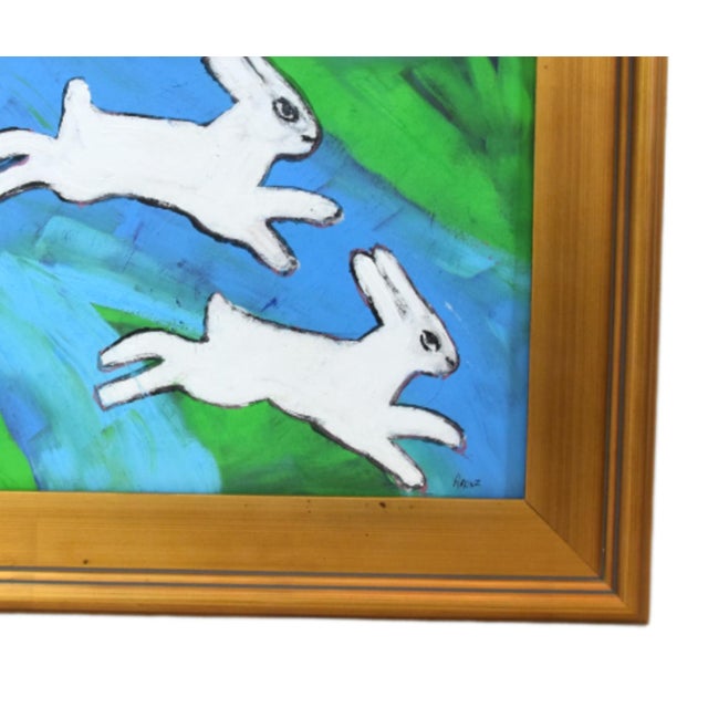 Original one-of-a-kind folk art oil painting of two bunnies, rabbits, hares running on an artist's panel. The talented...