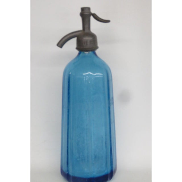 This stunning Seltzer Bottle is made out of glass with a metal topper. This Seltzer Bottle has brilliant paneled style to...