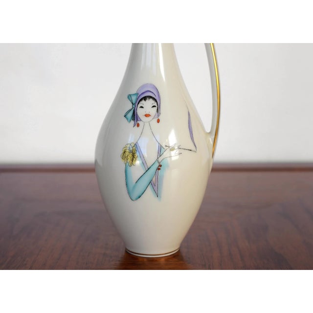 An utterly charming Lindner Kueps Bavaria vase from 1950s Germany featuring handprinted artwork of a very stylish and chic...