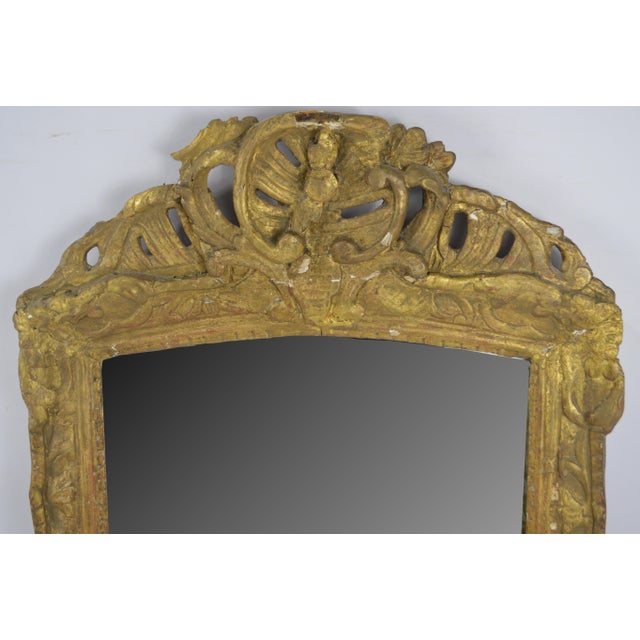 An antique c. 18th Century Italian giltwood mirror. This mirror was almost certainly performing reflective duties (or...