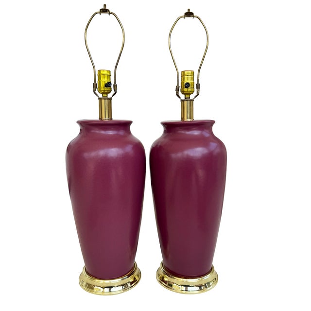 Striking pair of vintage oxblood ceramic table lamps featuring richly colored glazed bodies, polished brass bases and...
