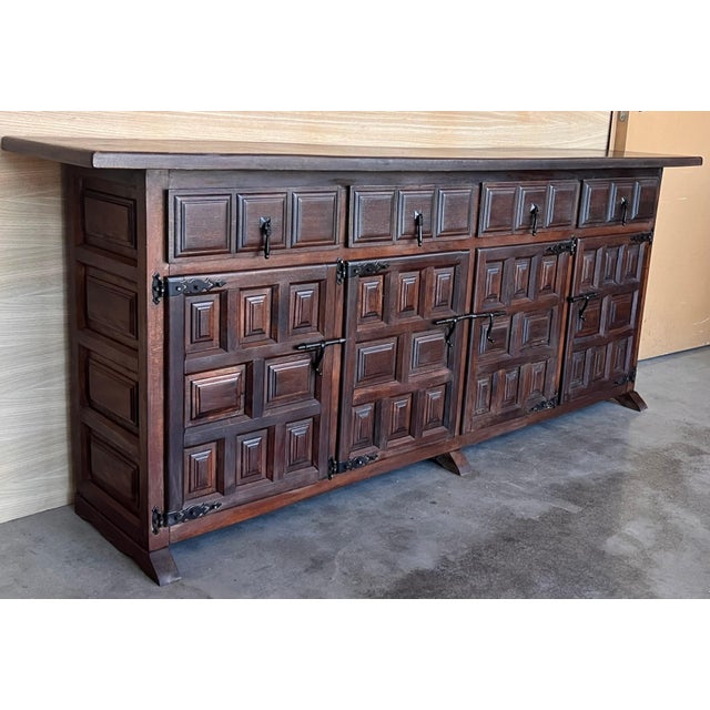 From Northern Spain, constructed of solid walnut, the rectangular top with molded edge atop a conforming case housing four...