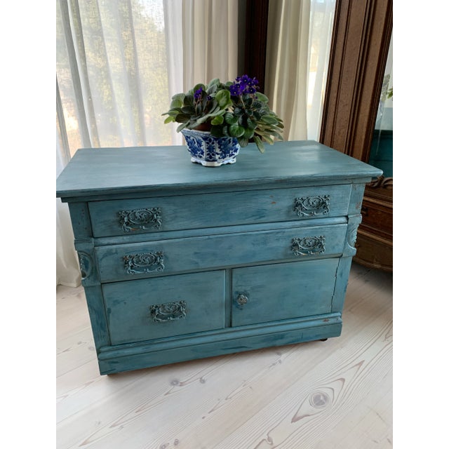 Here we have a small antique blue commode chest. Made of solid oak by the Munk & Roberts Furniture Company in Connersville...