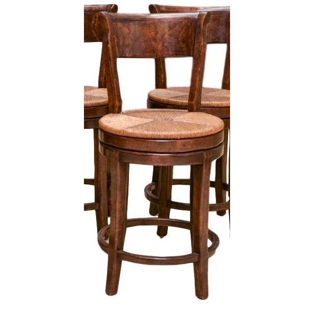 A set of five vintage high quality Guy Chaddock swivel counter height stools with rush seats and old world pegged mortise...