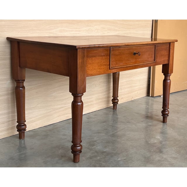 This elegant fruitwood desk was created in France, circa 1920. Made of blond walnut timber, the large writing table sits...