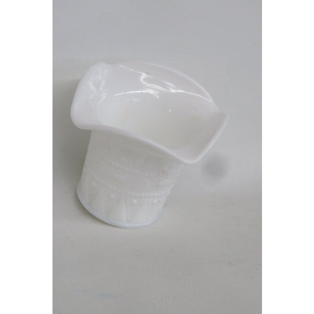This lovely Small Basket Vase is made out of white milk glass. This charming piece offers timeless vintage versatility and...