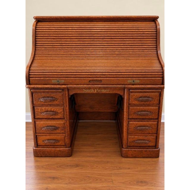 An extraordinary example of antique American office furniture, this magnificent Smith Premier roll-top desk combines...