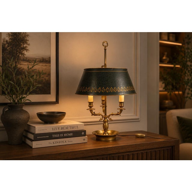 Empire style bouillotte lamp dating to circa the 1910s. Three curved arms with swan-head motifs radiate from a central...