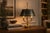 Empire style bouillotte lamp dating to circa the 1910s. Three curved arms with swan-head motifs radiate from a central...