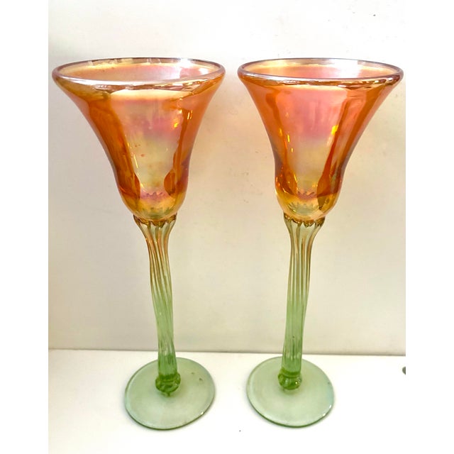 A striking pair of handblown art glass goblets by American glass artist Rick Strini, with dramatically flared iridescent...