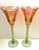 A striking pair of handblown art glass goblets by American glass artist Rick Strini, with dramatically flared iridescent...