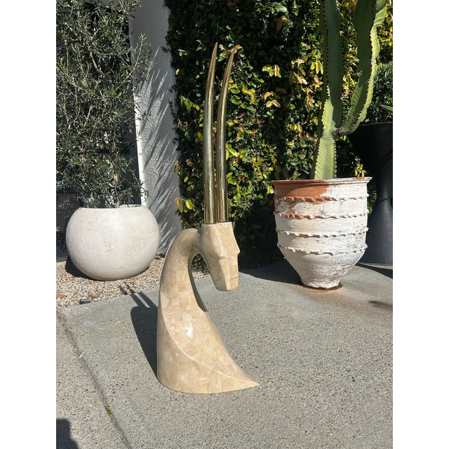 Vintage Maitland Smith antelope sculpture featuring a tessellated marble base and elongated polished brass horns. This...