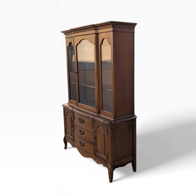 Queen Anne style wood and glass china hutch cabinet with arched glass doors, lower cabinet storage, and shaped carved...